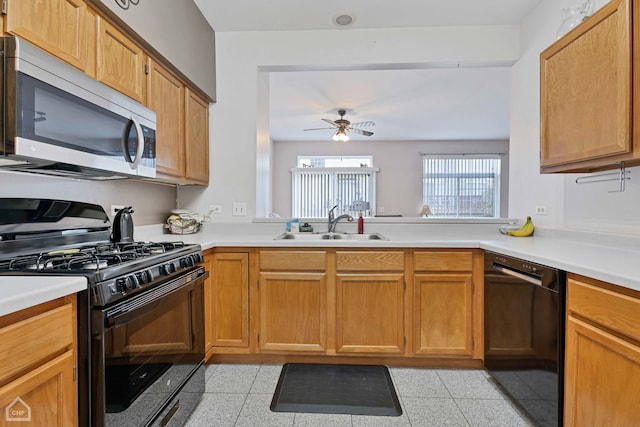 kitchen with sink, black appliances, and ceiling fan