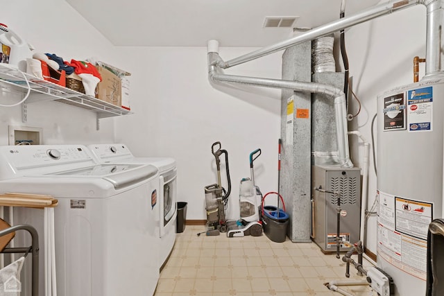 laundry area with separate washer and dryer and gas water heater