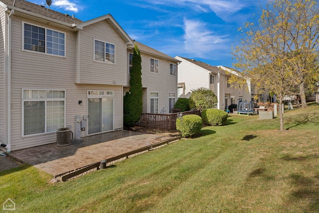 back of property with a patio area, a deck, and a yard