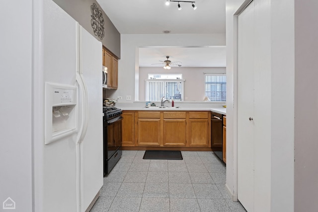 kitchen featuring sink, black appliances, and ceiling fan