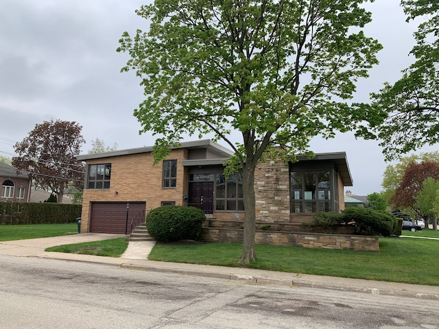 view of front of home with a front yard and a garage