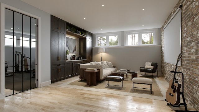 living room with light hardwood / wood-style floors and brick wall