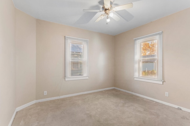 carpeted empty room featuring ceiling fan