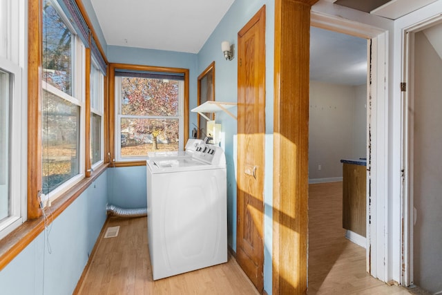 laundry area with light wood-type flooring