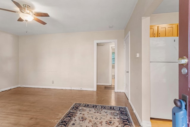 spare room with hardwood / wood-style floors and ceiling fan