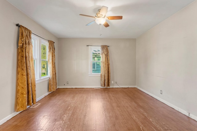 empty room with ceiling fan and wood-type flooring