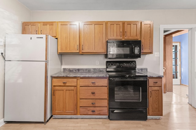 kitchen featuring light hardwood / wood-style flooring and black appliances