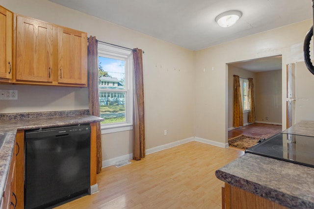 kitchen with black appliances and light hardwood / wood-style floors