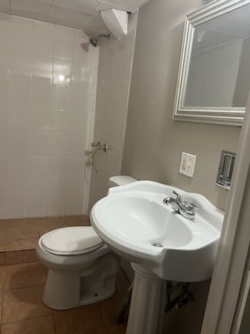 bathroom featuring tile patterned floors and toilet