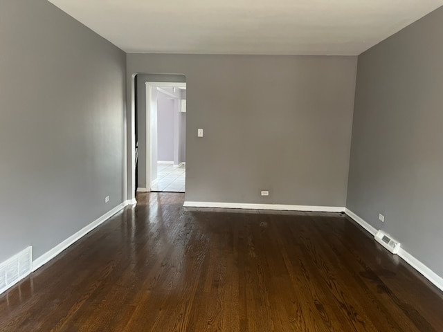 unfurnished room with dark hardwood / wood-style floors