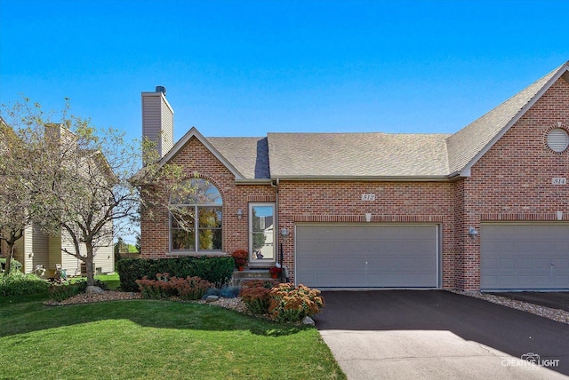 view of front of house with a garage and a front yard