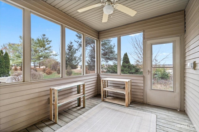 unfurnished sunroom featuring ceiling fan