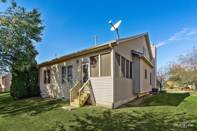 rear view of house featuring a lawn