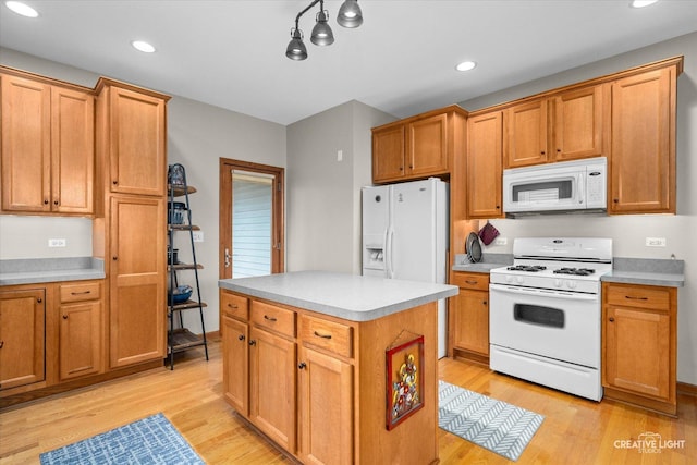 kitchen featuring a center island, light hardwood / wood-style floors, and white appliances