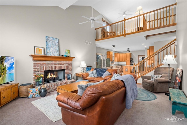 carpeted living room with a fireplace, high vaulted ceiling, and ceiling fan