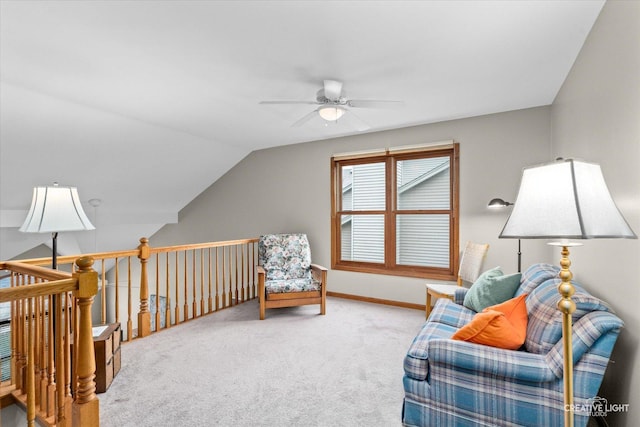 living area featuring carpet flooring, vaulted ceiling, and ceiling fan