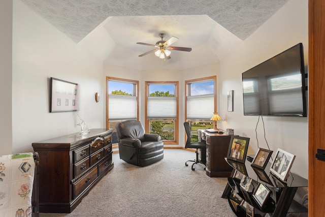 home office with light carpet, a textured ceiling, vaulted ceiling, and ceiling fan