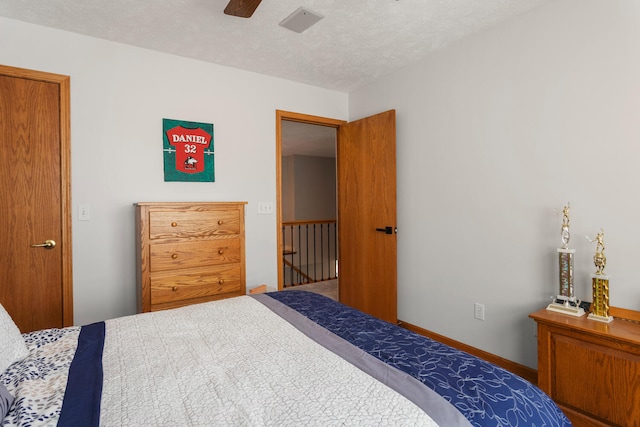 bedroom featuring a textured ceiling and ceiling fan