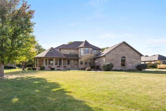 view of front of home with a porch and a front yard