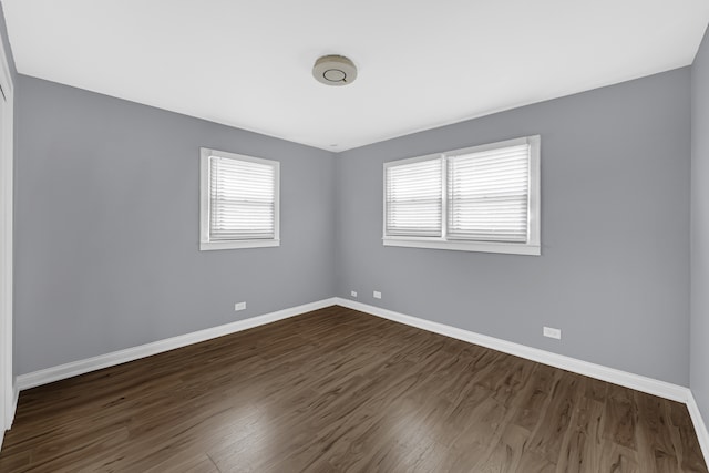 unfurnished room with dark hardwood / wood-style floors