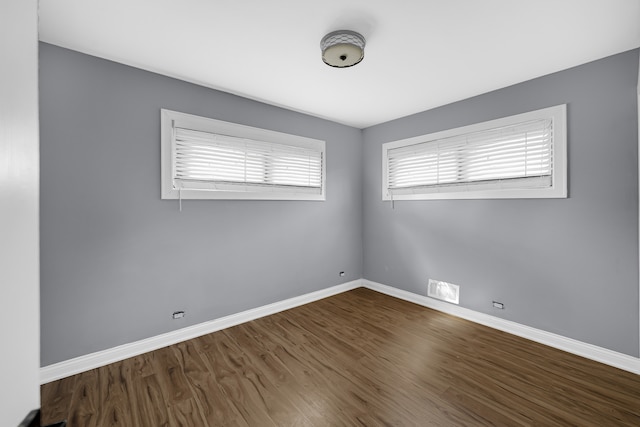 spare room featuring dark hardwood / wood-style flooring