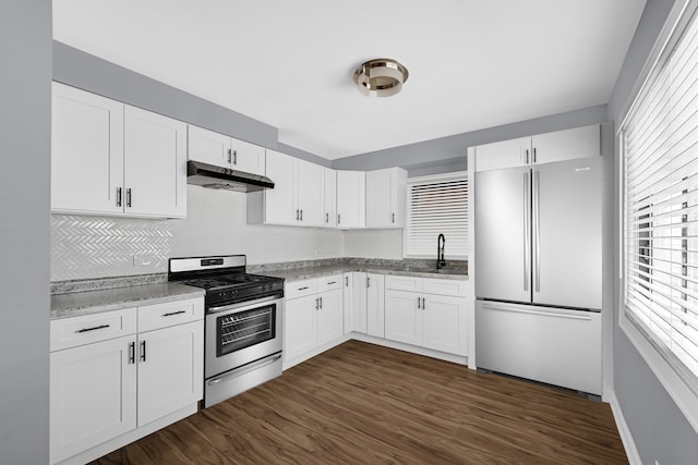 kitchen featuring white cabinets, sink, stainless steel appliances, light stone countertops, and dark hardwood / wood-style flooring