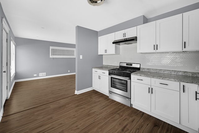 kitchen with dark wood-type flooring, decorative backsplash, stainless steel gas range, and white cabinets