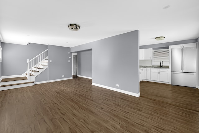 unfurnished living room with sink and dark hardwood / wood-style flooring