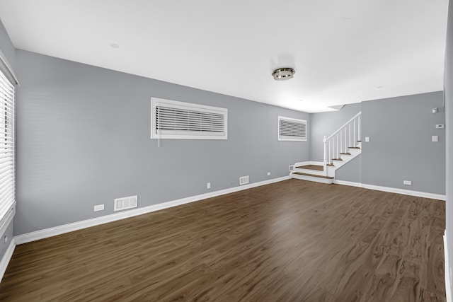 unfurnished living room featuring dark wood-type flooring