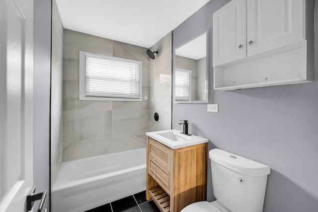 full bathroom featuring vanity, tile patterned flooring, toilet, and tiled shower / bath combo