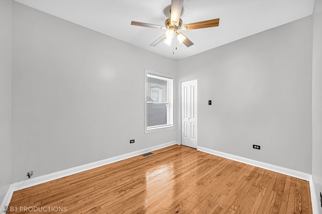 empty room with light hardwood / wood-style floors and ceiling fan