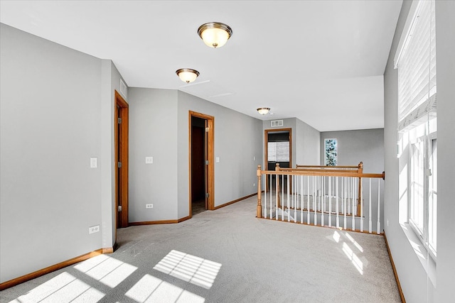 hallway featuring light carpet