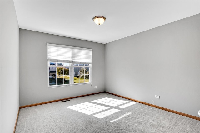 unfurnished room with light carpet