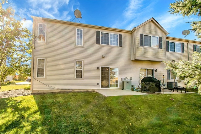 rear view of property featuring central AC, a yard, and a patio