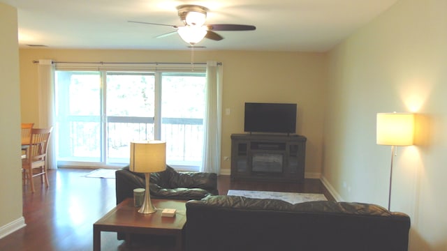 living room featuring hardwood / wood-style flooring and ceiling fan