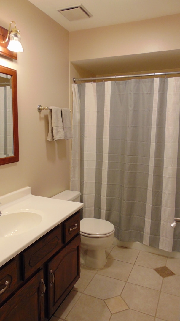 bathroom featuring vanity, toilet, and tile patterned floors