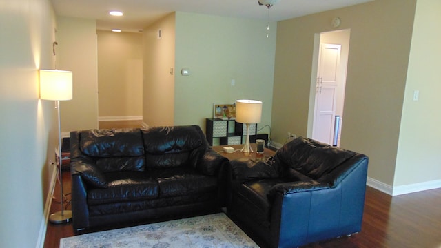 living room with dark hardwood / wood-style flooring