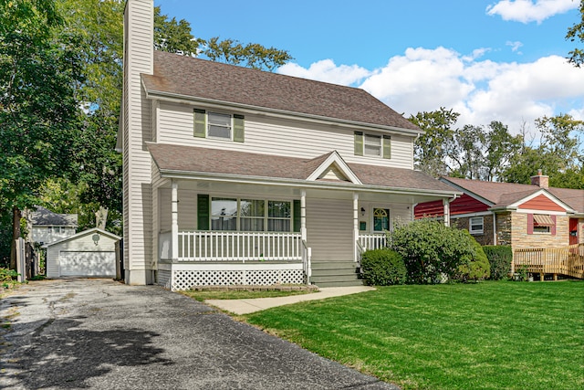 view of front of home with a garage, a front yard, an outbuilding, and covered porch