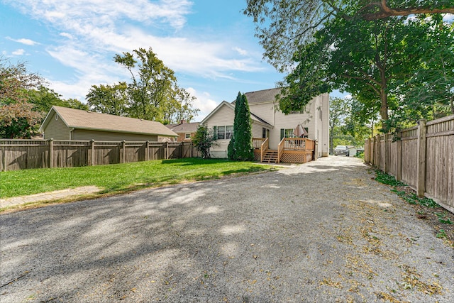 exterior space featuring a yard, a fenced backyard, and a wooden deck