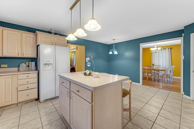 kitchen with an inviting chandelier, white refrigerator with ice dispenser, light countertops, and light tile patterned flooring