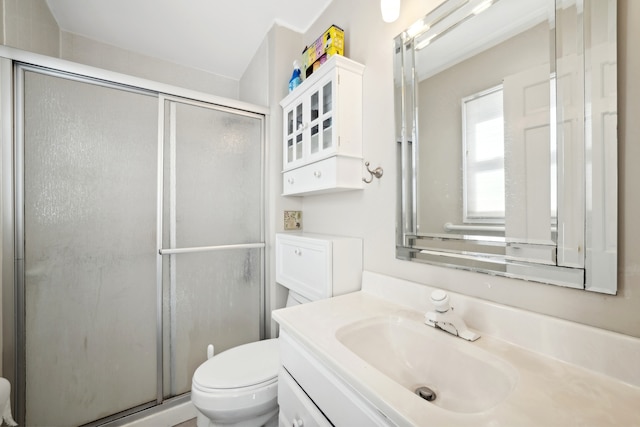 bathroom featuring vanity, toilet, and walk in shower