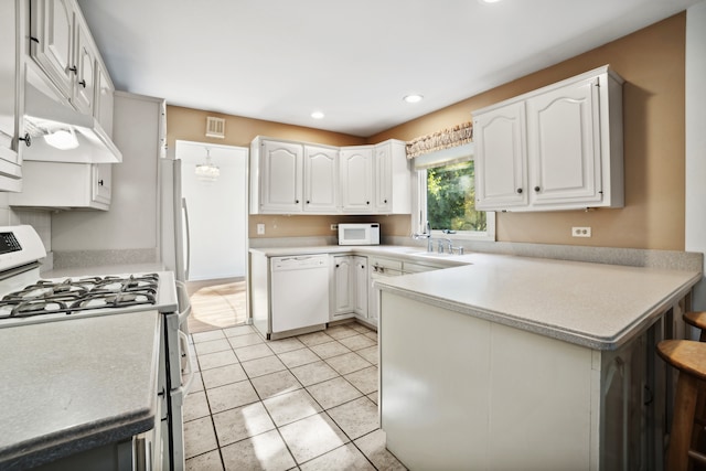 kitchen with light tile patterned floors, white cabinets, and white appliances