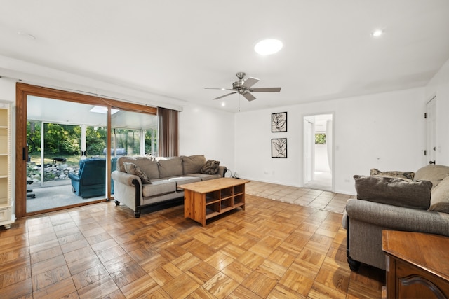 living room with ceiling fan and light parquet flooring