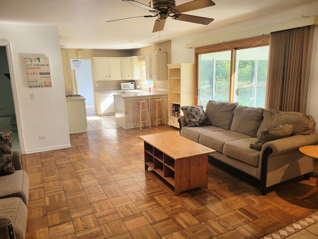 living room featuring light parquet flooring and ceiling fan