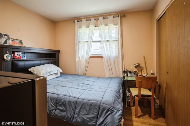 bedroom with a closet and hardwood / wood-style flooring