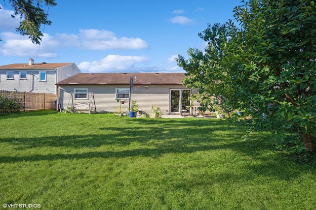 rear view of house featuring a lawn