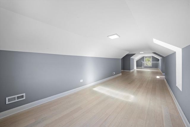 bonus room featuring vaulted ceiling and light hardwood / wood-style flooring