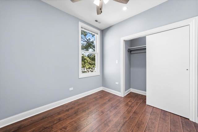 unfurnished bedroom with ceiling fan, a closet, and dark hardwood / wood-style floors