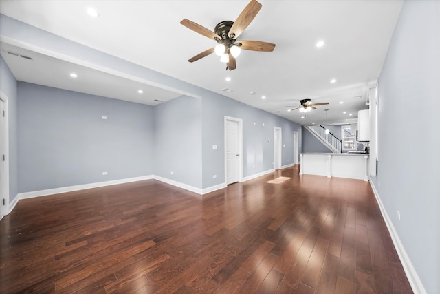 unfurnished living room with ceiling fan and dark hardwood / wood-style floors