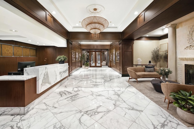 welcome area featuring decorative columns and a fireplace